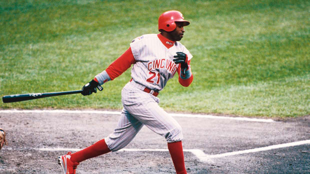 Deion Sanders swings during a baseball game.